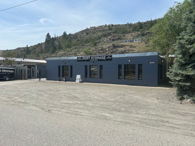 A small building with a sign reading 'Lumberjack Lounge' in a rural area.